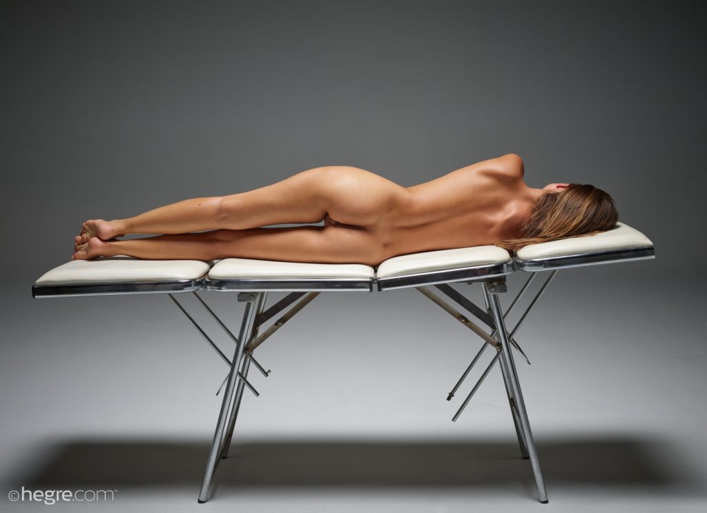 Natalia lounging naked on massage table 01